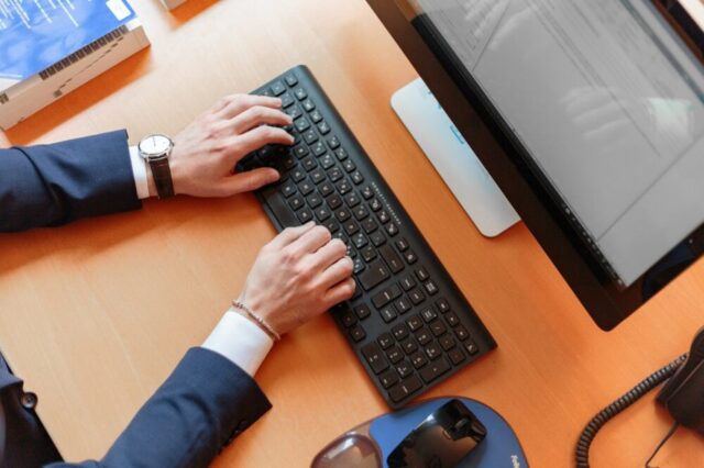 man typing computer