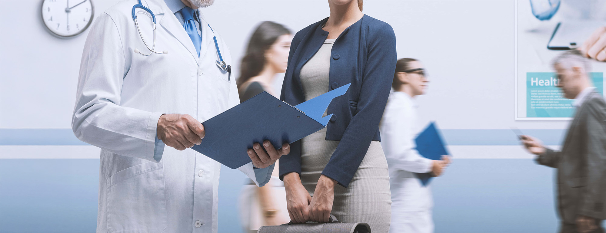 Doctor meeting a patient in the hospital aisle