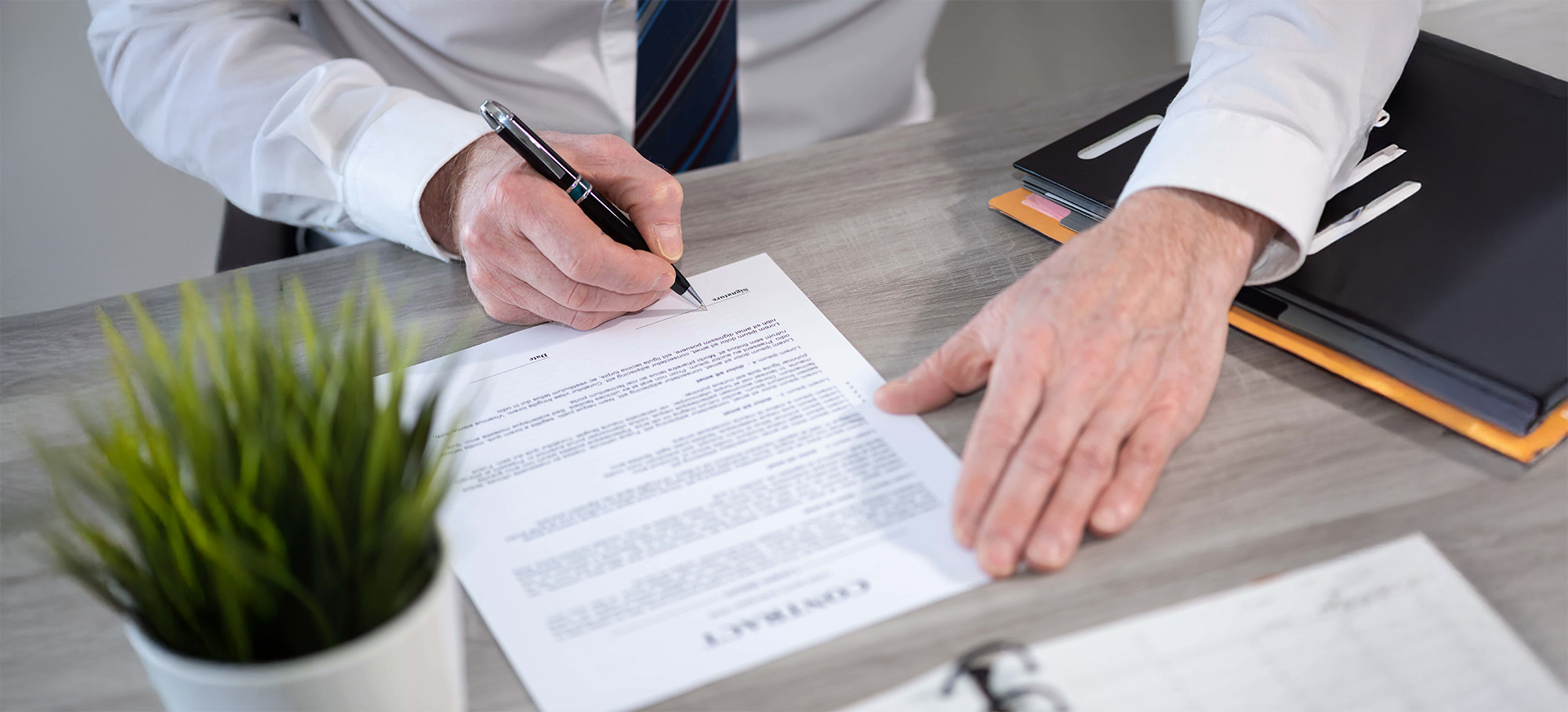 Hand of businessman signing a document