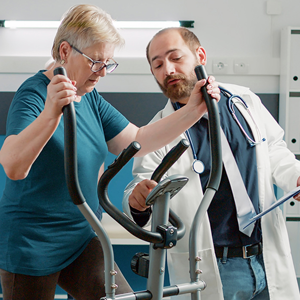 Senior patient doing muscle exercise on stationary bicycle
