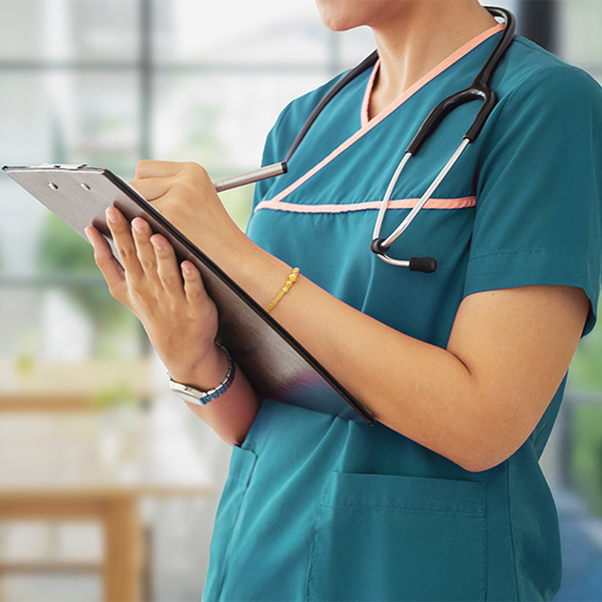 nurse filling out paperwork on clipboard